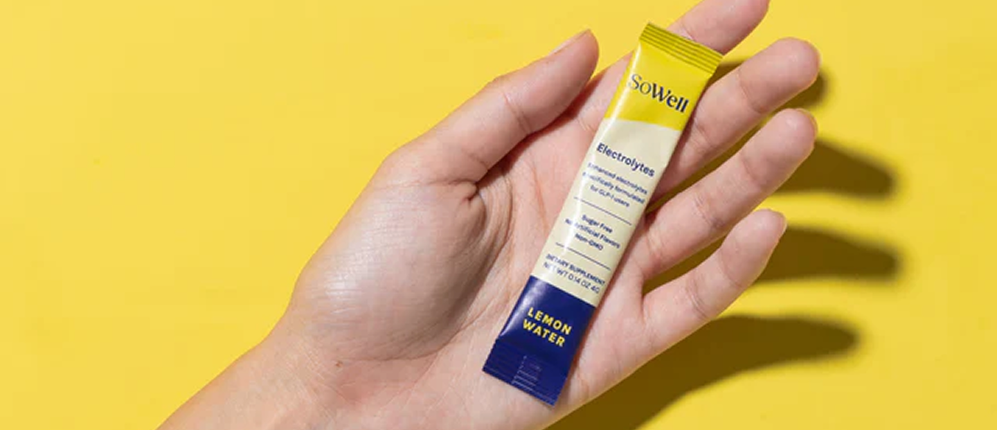 SoWell product held in hand on a yellow background